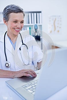 Female doctor using her laptop computer