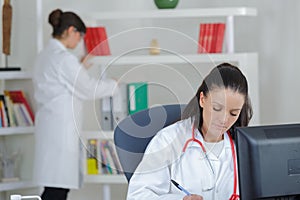Female doctor using laptop computer at clinic
