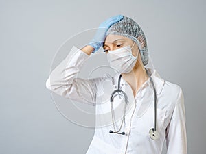 Female doctor using mask stressed with hand on head