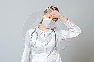 Female doctor using mask stressed with hand on head