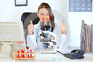 Female doctor using microscope in laboratory