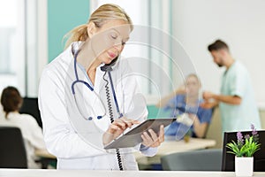 female doctor using phone in clinic at hospital