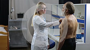 Female doctor using stethoscope to exam patient