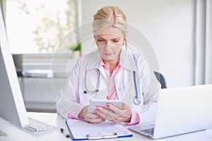 Female doctor using toucpad at the private clinic