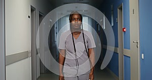 A female doctor walks along an empty corridor of the hospital