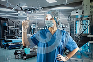 female doctor wear blue uniform with gloves, face mask glasses holding syringe with medication