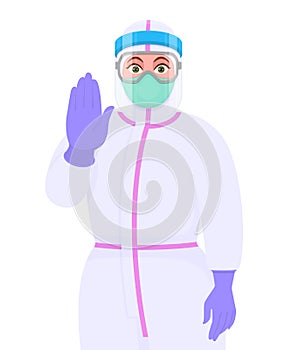 Female doctor wearing personal protective equipment PPE suit, face mask and showing stop sign. Physician or surgeon gesturing