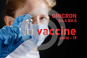 A female doctor wearing a protective mask holds a ba.5 and ba.4 omicron vaccine. Omicron BA.4 BA.5 . Covid 19 alpha