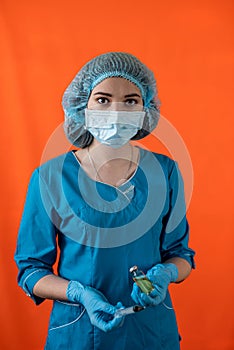 female doctor wearing white coat holding syringe smiling isolated solid color background.