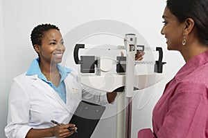 Female Doctor Weighing Patient photo