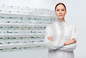 Female doctor in white coat at optical store photo