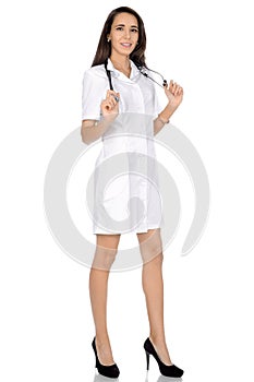 Female doctor in white medical clothes with stethoscope in hands photo