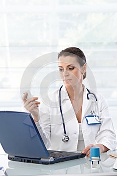 Female doctor working at desk