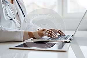 Female doctor working with her laptop