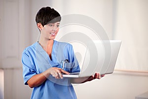 Female doctor working on her laptop