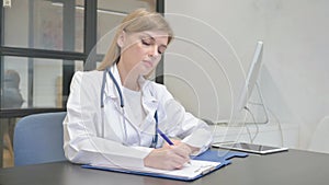 Female Doctor Writing a Document, Medical Report