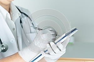 Female doctor writing medical information in notebook at hospital