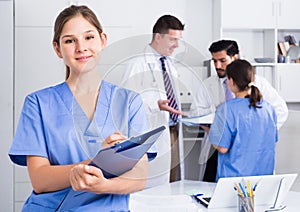 Female doctor writing notes on clipboard