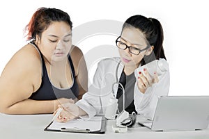 Female doctor writing prescriptions to her patient