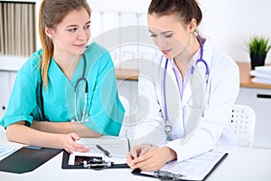 Female doctor and young surgeon intern in hospital