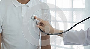 Female doctors perform a pulse examination using a headphone cable. Initial health check-up at the hospital. Medical and health