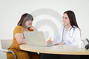 Female doctors perform treatment and examine symptoms of obese female patients.