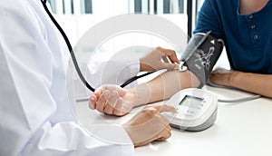 Female doctors use blood pressure monitors and stethoscope to measure pulse Diagnose the patient`s disease in a modern hospital m