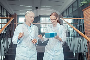 Female doctors in white coats on the stairs