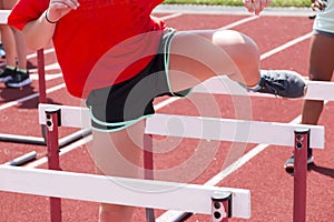 Female doing hurdle drills on the track