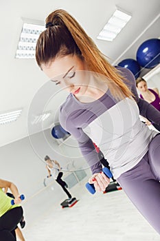 Female Doing Step Aerobics In Gym