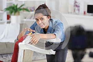 female doing vblog while fixing chair