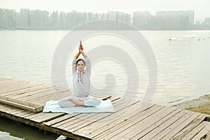 Female doing yoga exercise outdoor in the city park