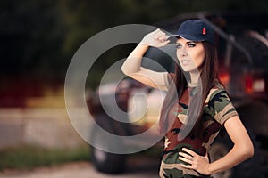 Female Driver in Army Outfit Next to an Off Road Car