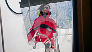Female driver of a boat is glancing around