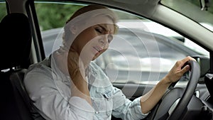 Female driver feeling neck pain, back muscle inflammation, sedentary lifestyle