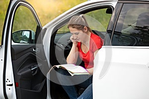 Female driver got lost while driving in countryside and reading