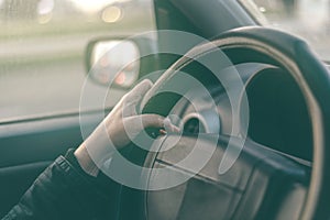 Female driver hands griping steering wheel