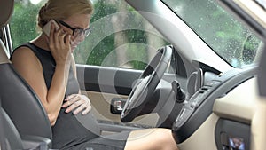 Female driver having pregnancy problems calling 911, first aid, risk of misbirth