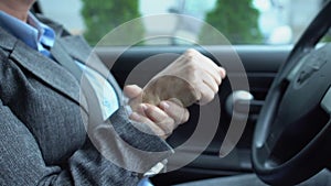 Female driver holding steering wheel, feeling sharp pain in wrist, joint injury