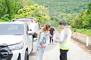 A female driver insurance agent writing the details on the claim report form