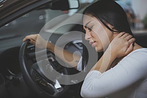 Female driver rubbing her aching neck after long drive