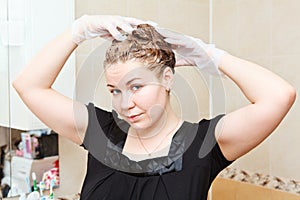 Female dyeing hairs at home photo