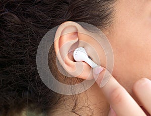 Female ear with earphone