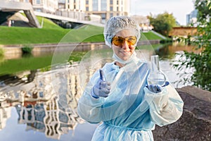 Female ecologist or epidemiologist points to excellent urban water quality