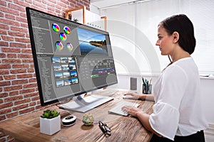 Female Editor Editing Video On Computer
