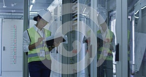 Female electrical worker reading paperwork