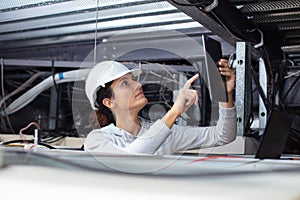 female electrician checking tablet