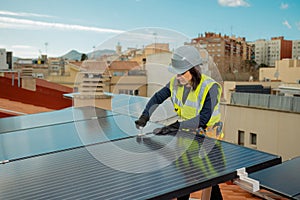 Female electrician engineer installing photovoltaic Solar Panels on city rooftop