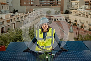Female electrician engineer portrait by photovoltaic Solar Panels city rooftop