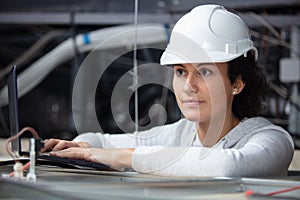 female electrician fixing ceiling wiring